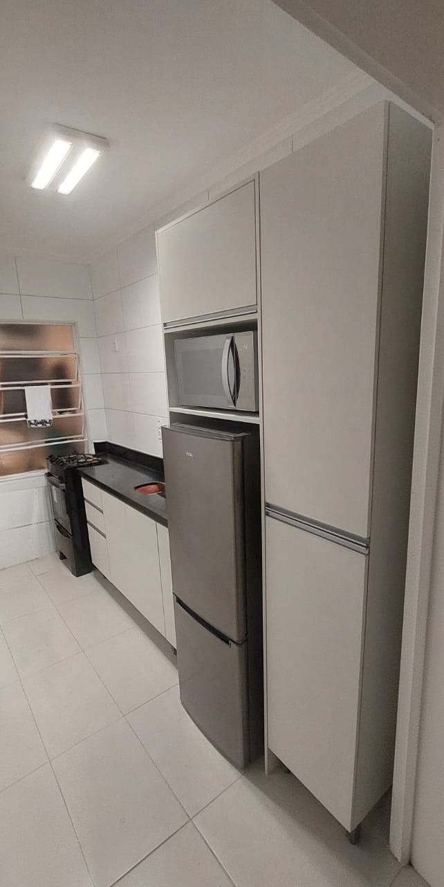 Cozinha compacta com torre de eletrodomésticos e marcenaria planejada